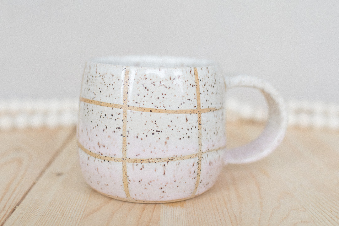 pink and white ceramic grid mug