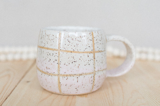 pink and white ceramic grid mug